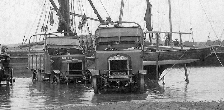  Barge GOLDEN FLEECE unloading timber on Mersea Hard. The lorries are ex-Army World War I lorries with solid tyres.
The left lorry NO1671 is from Clifford White, driver Jack Heard, mate Tom Cudmore. Right NO3942 is a Primrose Bus Company, driver Herbert Green, mate Rupert Green. 
Cat1 Barges-->Pictures Cat2 Transport - buses and carriers Cat3 [Display on front screen]