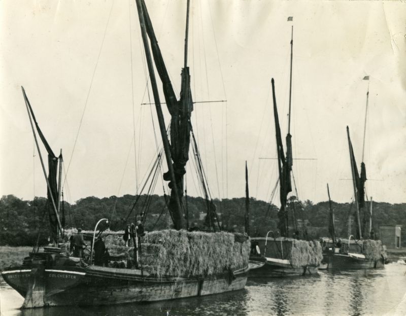 Revival of straw trade. Stackies being towed down Colchester River in 'convoy', bound for Ridham and the Kent paper mills. The left hand barge is BRITISH EMPIRE registered COLCHESTER and the middle barge is MAYLAND.

Used in Last Stronghold of Sail by Hervey Benham, page 178

BRITISH EMPIRE was built 1899 by Stone Bros., Brightlingsea Bros at Brightlingsea for Henry Howe of Colchester and ...
Cat1 Places-->Colchester-->Hythe Cat2 Barges-->Pictures Cat3 Places-->Colne