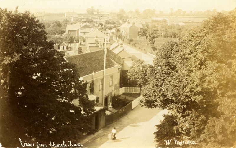  View from Church Tower, West Mersea to White Hart and looking north up High Street. The open space just right of centre became the Primrose and later Eastern National bus park. Hammond postcard, mailed 1911. 
Cat1 Mersea-->Road Scenes Cat2 Mersea-->Pubs