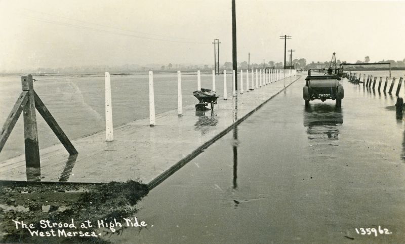  The Strood at high tide, looking inland. Contractors working on the right beyond the car. Open top car no TW537.

Postcard 135962. TW registrations were issued September 1925 to June 1927. Other photographs date this widening of the Strood to 1931. 
Cat1 Mersea-->Strood