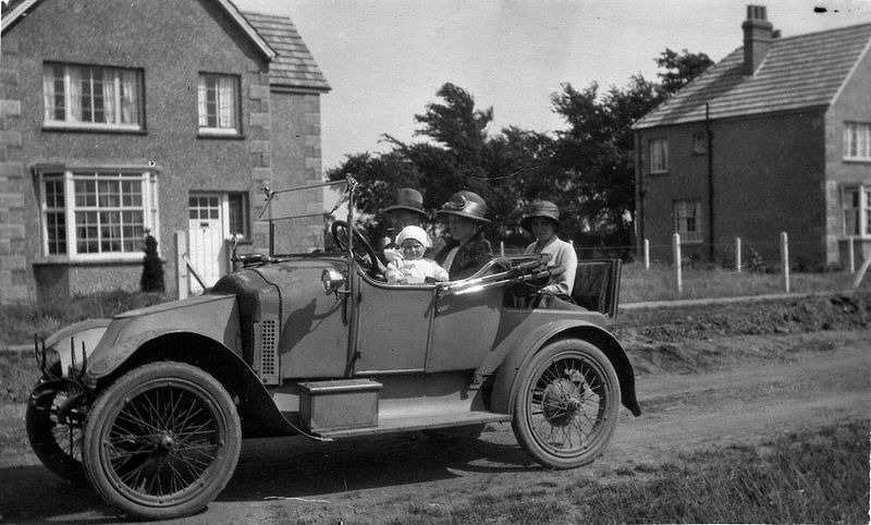  Seaview Avenue 1922/23. The car is a Clement Bayard (1913 ?) model owned by Mr Edwards, 187 Harlesden Road, Willesden Green. Driver Leslie Edwards. Mrs Weaver and son Peter in front seat. Mrs Ethel Edwards in dickey seat. 
Cat1 Mersea-->Road Scenes Cat2 Transport - buses and carriers