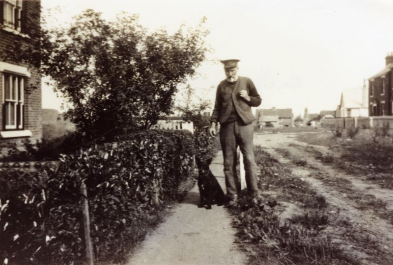  William Wyatt in City Road. The dog's name is Jip because he gave William jip by running away on the marshes when Bill was wildfowling (Harold Cutts). 
Cat1 Mersea-->Road Scenes Cat2 People-->Other