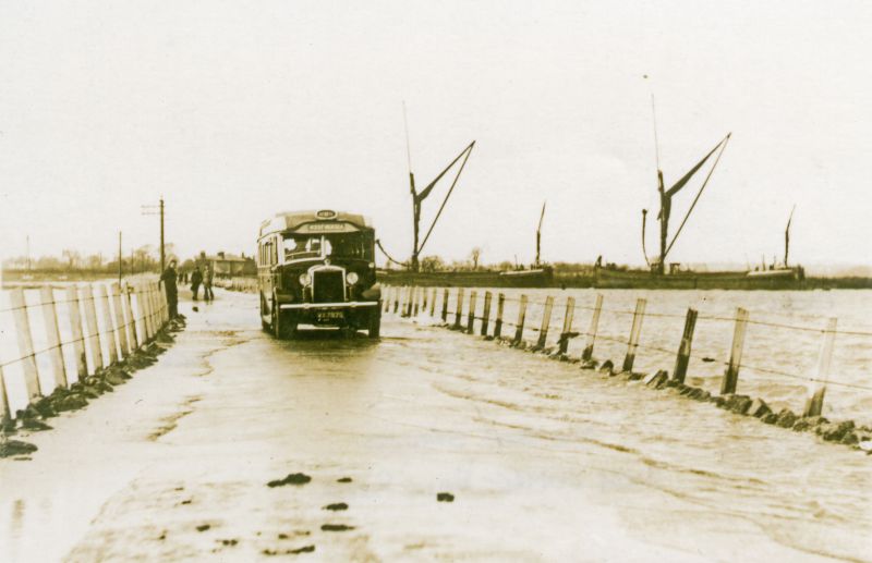  Mersea Strood. Barge NELLIE PARKER in centre. Berrys' Gilford Model 1680T 31 seat Coach VX7875, purchased by Eastern National in 1937 Fleet No 3701.

NELLIE PARKER Official No. 112619, built Ipswich 1899. She sank off the Isle of Grain in 1959, raised and derelict in Milton Creek by 1980.

The last owner as far as I am aware of Nellie was Peter Horlock of Ipswich. Last skipper was Brian ...
Cat1 Transport - buses and carriers Cat2 Mersea-->Strood Cat3 Barges-->Pictures