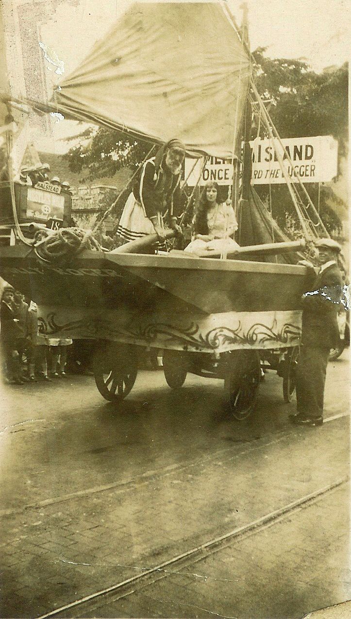  Mersea Island entry winnner in Colchester Carnival Cup competition. Once aboard the lugger. Coal cart from Clifford White & Co. On the boat are William Wyatt, and Mrs C. Mole (now Mrs C. Clarke) next to the mast. 
Cat1 Mersea-->Events Cat2 Transport - buses and carriers