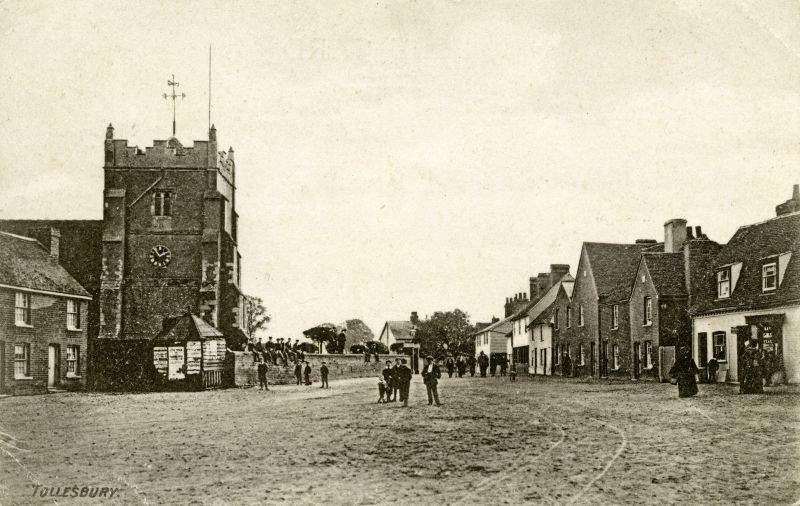  Square and Church, Tollesbury. Postcard mailed 26 April 1905.

A recent reprint has the following on the back:

Before 1907 when the foundation stone was laid for the Parish Room, this is a general view of The Square, also known as The Green. The village lock-up was used for bill-posting and even then, people sat on the church wall. At the time the Post Office was a private house. A ...
Cat1 Tollesbury-->Road Scenes