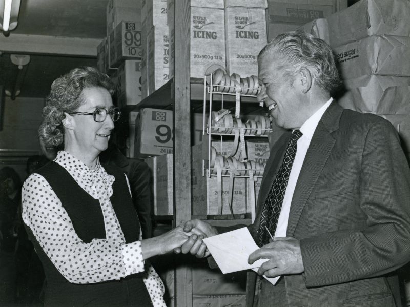  Dorothy Brown - presentation at the Co-op in Mersea. Dorothy Brown on the left and Geoff Green on the right.

This Co-op was on the corner of Kingsland Road and Barfield Road. The building is now a funeral parlour. 
Cat1 Families-->Stoker / Brown Cat2 Mersea-->Shops & Businesses Cat3 Families-->Green