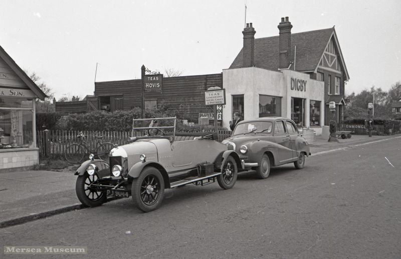  Old Morris Cowley PU9044 and Austin Somerset cars in Barfield Road. Digby's shop in background. 
Cat1 Transport - buses and carriers Cat2 Mersea-->Shops & Businesses
