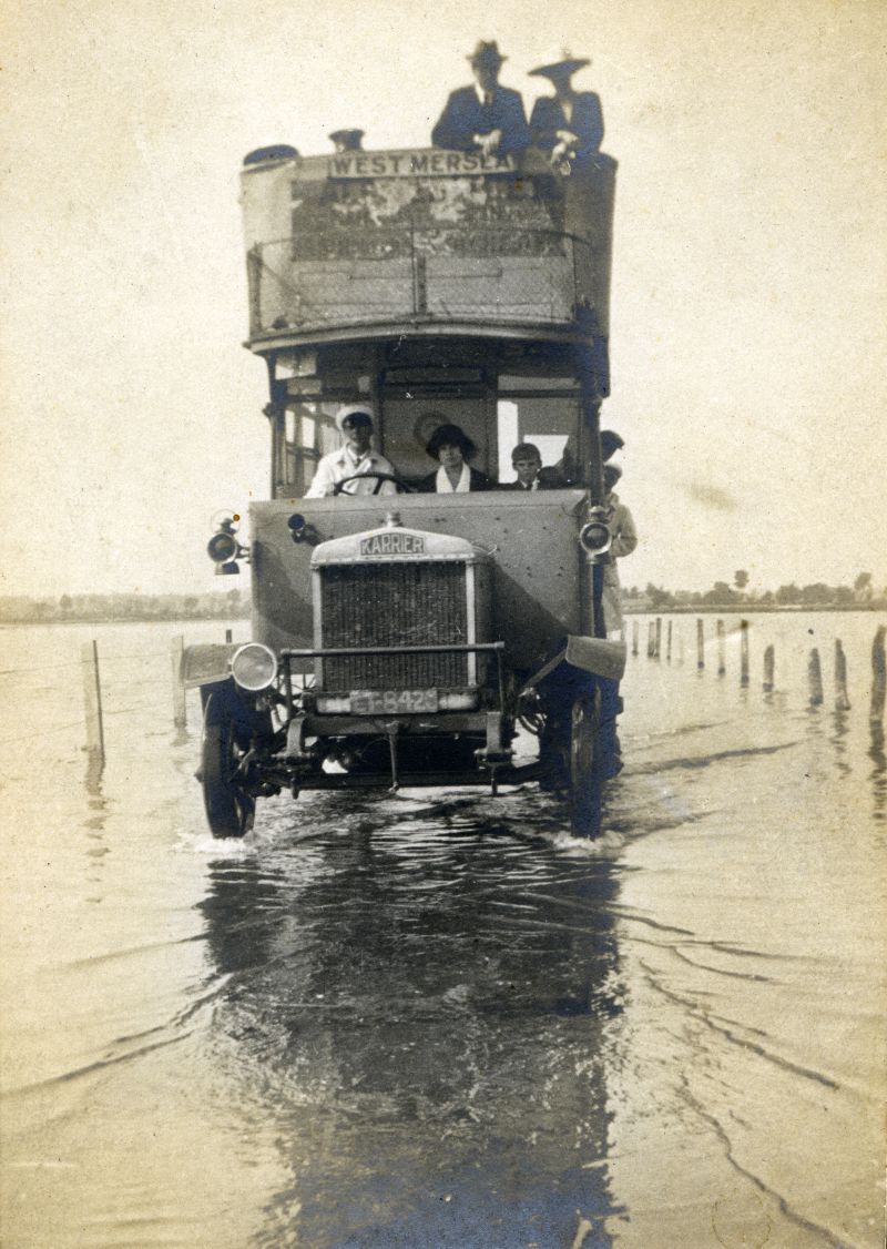  Alf Stacey and Primrose Bus crossing the Strood at high tide. Karrier, probably LT8426.

Photo used on cover of Just the Ticket by David Thornton, which says it is LF8420.

Primrose Buses were so called because they were painted yellow. The buses were run from 1918 by the Mersea, Colchester & District Transport & Bus Co. Ltd. They were based at the Primrose Garage in the High Street, ...
Cat1 Mersea-->Strood Cat2 Transport - buses and carriers