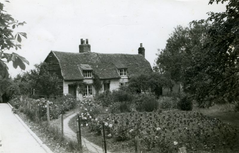  Cottage in Salcott where Nancy Cullum and her mother lived. Date not known but probably c1941. Pansies are growing in front of the cottage. See Farming Adventure by J. Wentworth Day about the growing of pansies in Salcott during the War - he does not find out why, but they were just being grown for seed, in front of the cottage and in another field further down the lane. 
Cat1 Places-->Salcott & Virley