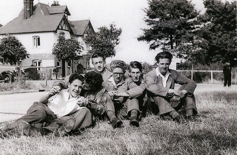  Mersea boys 1950s, Beach Club in the background. L to R 1. Gilbert Lee, Gerald Mason (or Roger Sheldrake), Geof Atkins, Colin 'Chicks' Milgate, Ken 'Chunky' Mole, John 'Dick' Gladwell. 
Cat1 People-->Other Cat2 Mersea-->Road Scenes