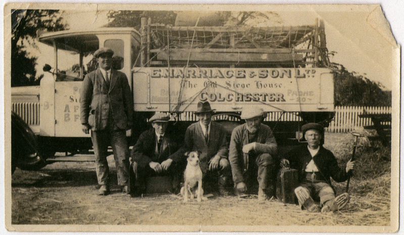  L-R ?, Arthur James Hoy, Tim Grandad's Dog, James Hoy Snr, J. Pudney.

Lorry from E. Marriage & Sons Ltd., The Old Siege House, Colchester. Phone 20. 
Cat1 People-->Other Cat2 Transport - buses and carriers
