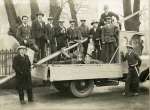 Fire Brigade before they had uniforms, on Horry Martin's lorry in front of West Mersea Church. 
L-R 1. Horry Martin, 2. Arthur Mills, 3. Edgar Jopson, 4. Ivan Mole, 5. Herbert Burgess, 6. Horry Whiting, 7. Mr Cathercole, 8. Alec C. Green, 9. Bob Key (Island barber Johnny Hart's old shop), 10. Leonard Mills, 11. Oscar Whiting.
</p><p>
Front left Horace Martin, builder, owner of the 'Dennis' lorry VW5608. His yard was where Fred's DIY now (2018) is. The yard and lorry were later owned by Clifford White. It was used for pill box work, and was driven by a Mr Waller. A. Tredget the builder bought it after WW2. (This lorry was fierce on the clutch - ask Ted Atkins). [Ron Green]
</p><p>
Herbert Burgess spent many years working for William Wyatt, the boat builders. He was also an officer in the Sea Cadets and taught us boys to play various instruments [Owen Fletcher].
</p><p>
The photograph appeared in the Daily Mirror 26 February 1929 with the caption Soon got very busy, - The fire brigade which has just been formed at West Mersea, Essex. It received several calls during the first few days of its existance.
</p><p>
Photograph taken the same time as <a href=mmphoto.php?typ=ID&hit=1&tot=1&ba=cke&rhit=1&bid=MMC_P669_011 ID=1>MMC_669_011 </a>. 1929.