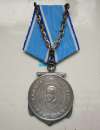  The Ushakov medal presented to Les Malshinger in a ceremony in Colchester Town Hall 27 November 2015, for his service in Arctic Convoys 1944-45. 
 See <a href=https://rusemb.org.uk/ushakov/ target=ssh>rusemb.org.uk/ushakov/</a>
</p><p>Photo by Doris Christmas</p>  PH01_MLR_009