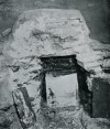  Opening of Romano-British Barrow opposite Page 129.
 View of the Tomb, showing Leaden Casket in place, with the covering boards removed and placed on either side, displaying the top of the Glass Urn within.
 From a flashlight phot by Mr S. Hazzledine Warren.  MOR_129_002