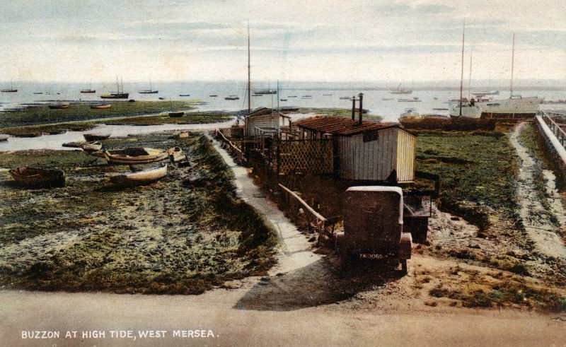  Buzzon at High Tide, West Mersea. House boats - AVEL and PEGGOTY upper right ? Smacks in the creek in the distance. Another copy of this postcard was mailed August 1928. 
Cat1 Mersea-->Houseboats Cat2 Mersea-->Coast Road