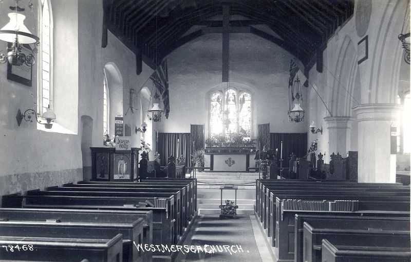  West Mersea Parish Church interior. Oil lamps and the 1905 East window. Large cross suspended from the roof, but it is a bare cross. Postcard 78468

Postcard 78468 sent to Miss Winifred Farthing in Essex County Hospital, 15 February 1923 
Cat1 Mersea-->Buildings