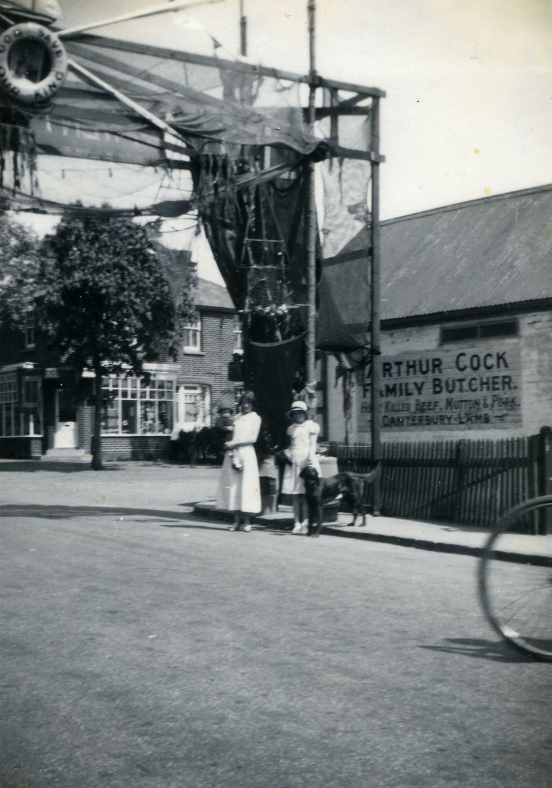  1935 Jubilee Arch corner of High Street and Yorick Road. Arthur Cock, Family Butcher.

Some of Dixon family with dog Pip under the arch ?

From Dixon family photographs. 
Cat1 Mersea-->Events Cat2 Mersea-->Road Scenes