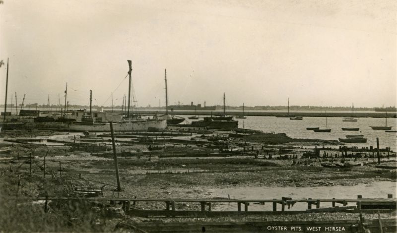 A distant view of the PHILOCTETES laid up in the River Blackwater c1947. She is the left-most of the two vessels in the river. The ketch BLACK FOX can be seen on the edge of the houseboats. Date: Before April 1947.