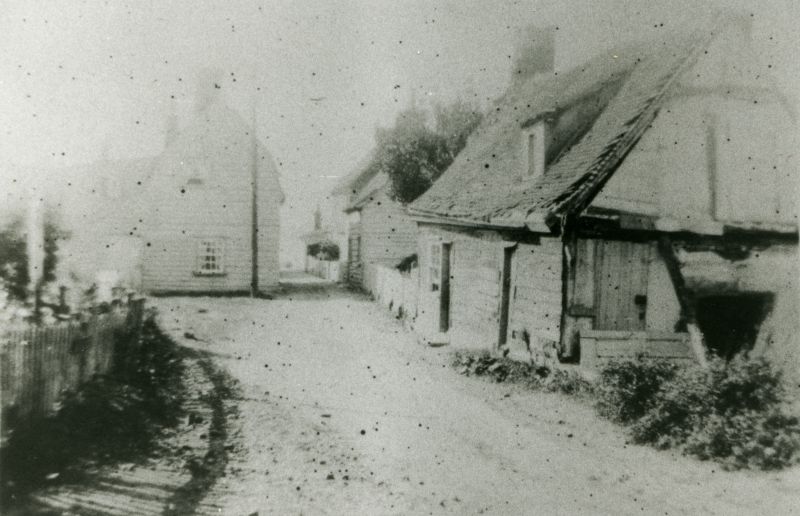  Cottages in the Lane, partially demolished, thought to be in the 1920s. The site is now The City Hall assembly hall was built on the site around 1930. The demolished cottages at one time had been The Ship Inn public house. 
Cat1 Mersea-->Pubs Cat2 Mersea-->Old City & the Hard