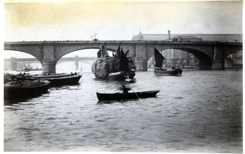  Stackie barge negotiating London Bridge with bridge sails.

Used in Down Tops'l page 14, which does not give the source of the photograph. 
Cat1 Barges-->Pictures Cat2 Places-->Thames
