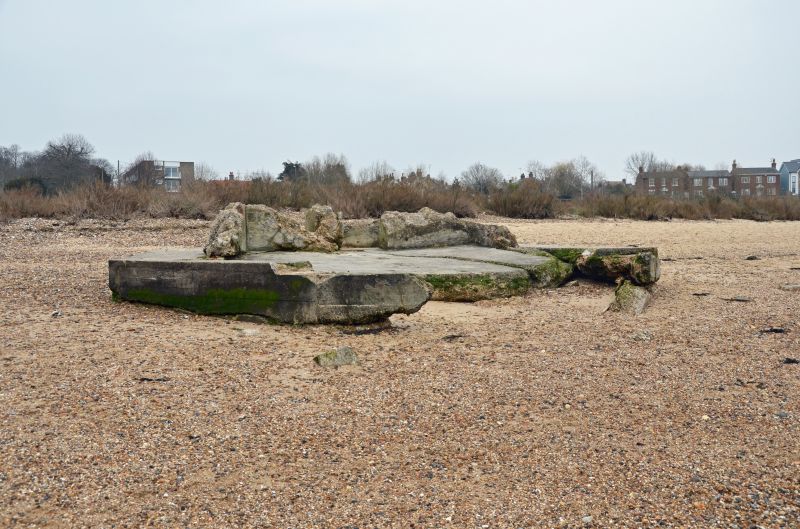  A walk round Mersea Island. WW2 remains of - the base of the pillbox to the west of the Monkey Beach. Coast Road is in the background, Rosebank flats on the left.

Essex SMR / EHER 21112. 
Cat1 War-->World War 2 Cat2 Mersea-->Buildings Cat3 Mersea-->Beach