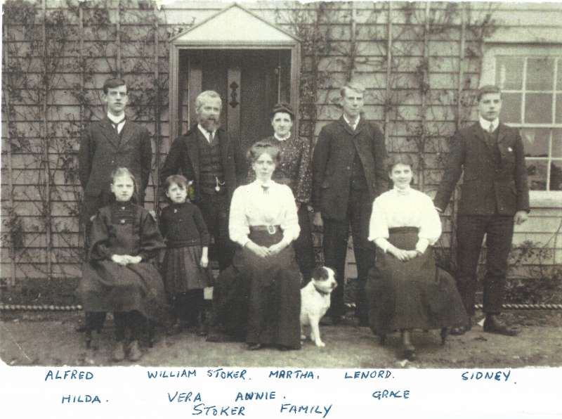  The Stoker family - a picture received by Andy Brown from Ken Stoker, son of Alfred. Ken is 91 in 2018. Andy thinks it is about 1910, which would give the following ages:

L-R back Alfred (18), William Stoker (51), Martha (48), Leonard (23)

Front Hilda (11), Vera (5), Annie (25), Grace (14), Sidney (18)

The photograph is outside Riverside House on Coast Road, West Mersea. 
Cat1 Families-->Stoker / Brown