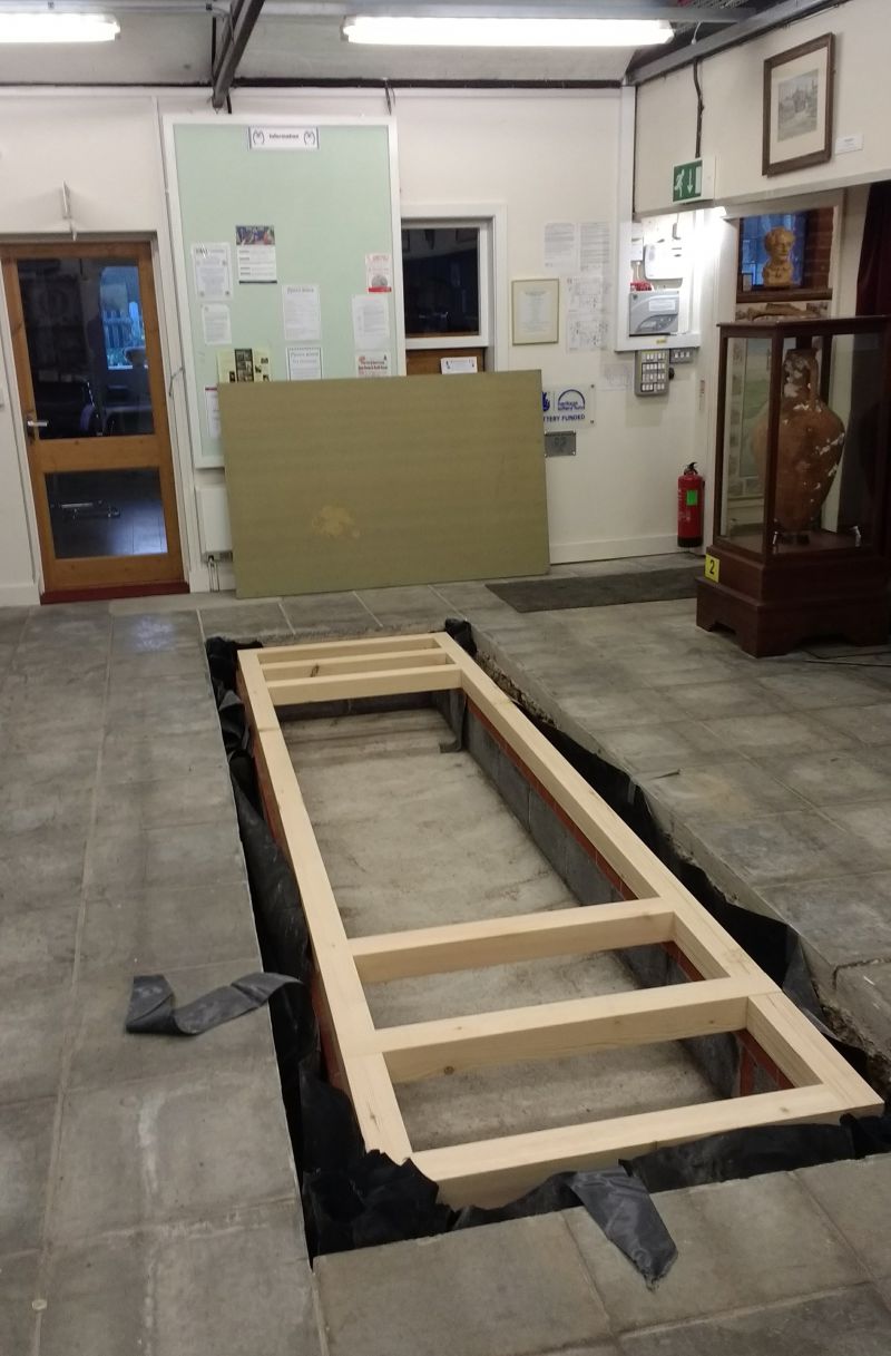 Excavation of hole in Museum floor to display board walk timbers.