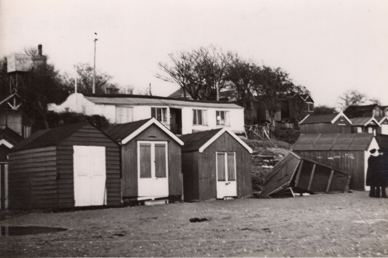  Beach Huts at West Mersea after the 1953 Flood. The Spinney Cafe is in the background. 
Cat1 Disasters and Mishaps-->on Land Cat2 Mersea-->Beach