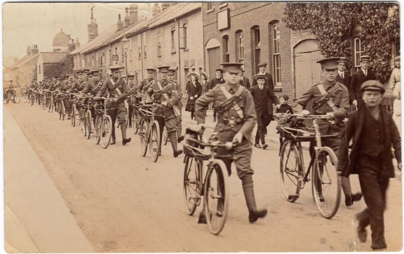  Cyclist Battalion WW1.

Card written to Miss Daisy Smith, West Mersea Mill.

Dear Daisy, 
...

This is a photo of our company just leaving our barracks on going to Camp. YOu can hardly see me. I am just behind Claude...

The guv is away at Felixstowe for the da going to London tomorrow ao I'm afraid much work won't be done. Love, Hugh 
Cat1 Families-->Smith Cat2 War-->World War 1