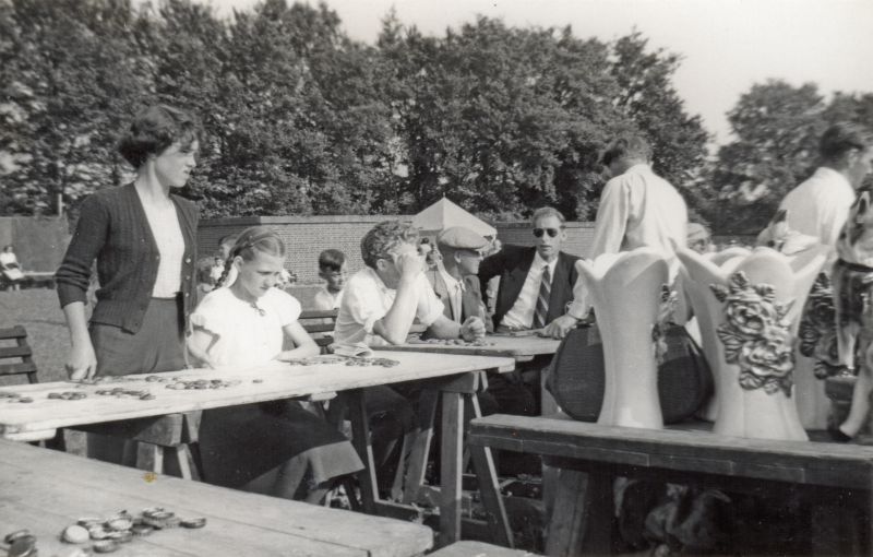  Behind the Legion with Air Raid Shelters in background.

Sheila Phillips standing left. Syd Milgate with dark glasses. 
Cat1 Mersea-->Events Cat2 Families-->Milgate