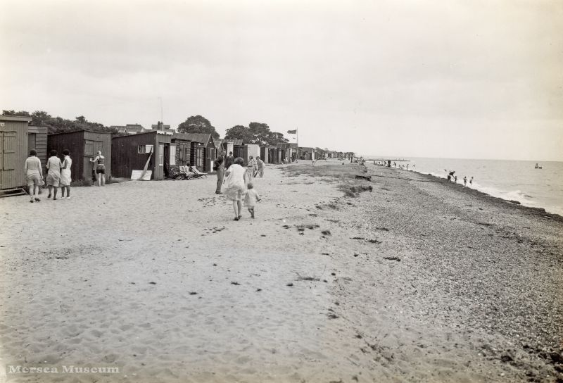  West Mersea Beach. The house Shameen at the bottom of Seaview Avenue is visible over the beach huts just left of centre. 
Cat1 Mersea-->Beach