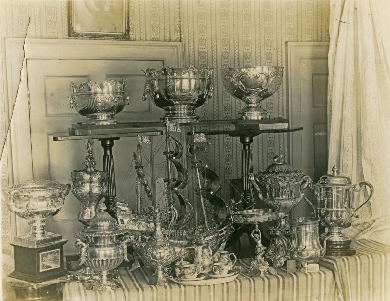  Tropies won by yacht CREOLE.

Top Southampton 1893, Weymouth T... 1910, St. Georges 1894.

Bottom 1. Thames 1904, Victoria 1904, Whittaker Wright 1900, Albert Cup 1901.

Bottom 2. Antwerp Challenger 1894-5, Lord Warden 1910.

Bottom 3. Victoria 1906, Niadhook ? 1891, Emperor 3rd 1907, Paget 1910. 
Cat1 Yachts and yachting-->Sail-->Larger