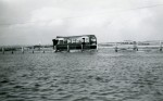 58. ID DBO_013 Eastern National bus going through the water at the Strood, in the days when bus services were not curtailed by the high tide. Ford Anglia Estate behind it ?
Cat1 Mersea-->Strood Cat2 Transport - buses and carriers