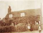 39. ID RG03_393 Vine Cottage, The Lane, West Mersea. 
It is thought the lady is Ellen Cooke née Ennew 1859 - 1904 and the photo taken c1903. The children could be ...
Cat1 Mersea-->Buildings Cat2 Families-->Cooke