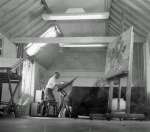  'Grimey' in his studio at the back of his house on the Peldon side of the Strood - the house was later known as 'Strood Close' and 'Pyefleet House'.
 Leslie Grimes was born in 1898. In 1927 he became cartoonist with the London Star. He moved to Ibiza in the early 1950s and died in London in 1983.  RG17_211