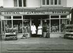  Oscar and Else Whiting outside their shop in Barfield Road. Some of the employees who worked here were Len Pullen, Mr Smith, Mrs Maskell, Rose Carter (Harvey), Brenda Whiting.
 From Album 11 Accession No. 2016-11-001K 2016.11.001K  FL11_027_003