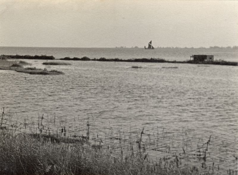  View across the cricket field below Coast Road, to the Blackwater. Sailing barge making its way upstream. The pill box is still intact - by 2000 only the base was there, and it is thought the main part was demolished soon after WW2.  UPA_051_001